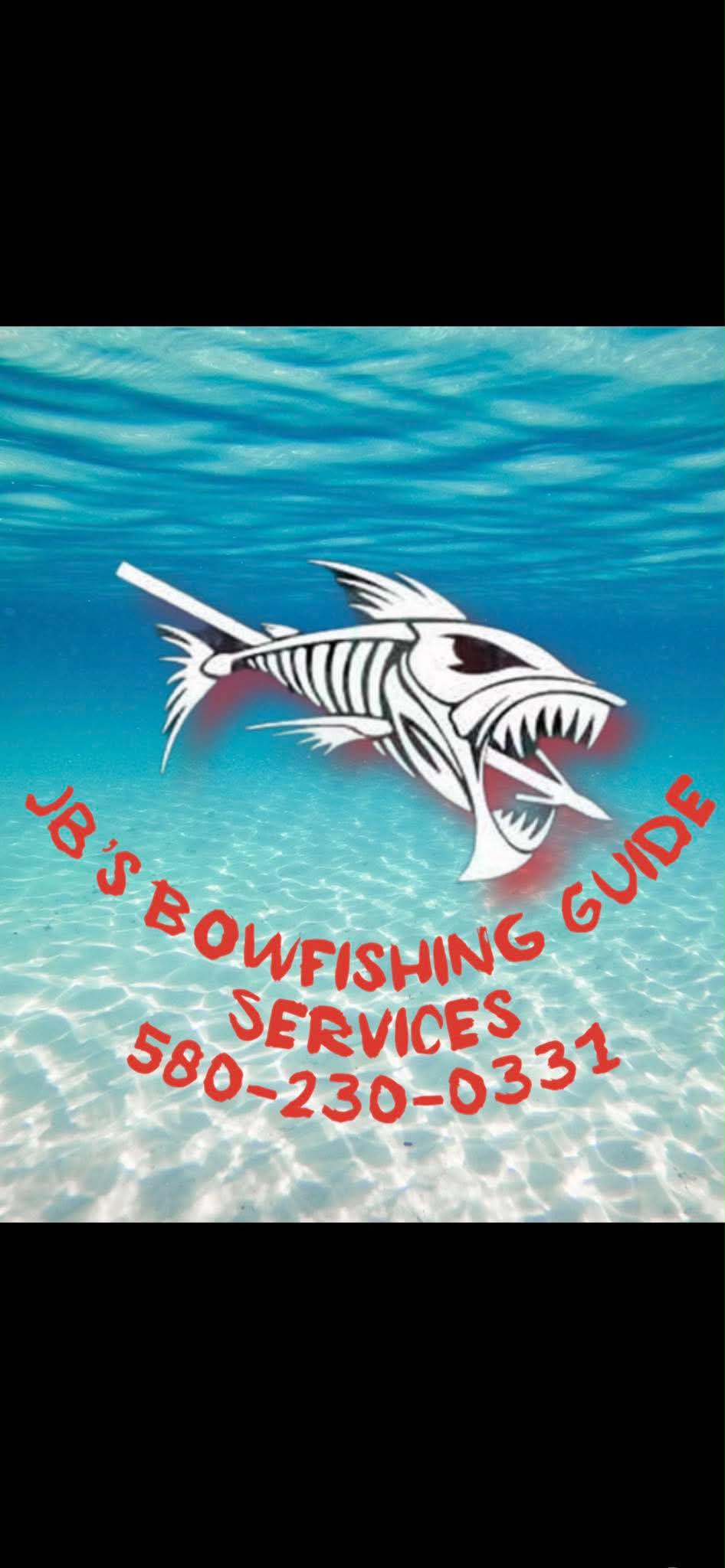 Bowfishing angler holding a large gar on a boat at night